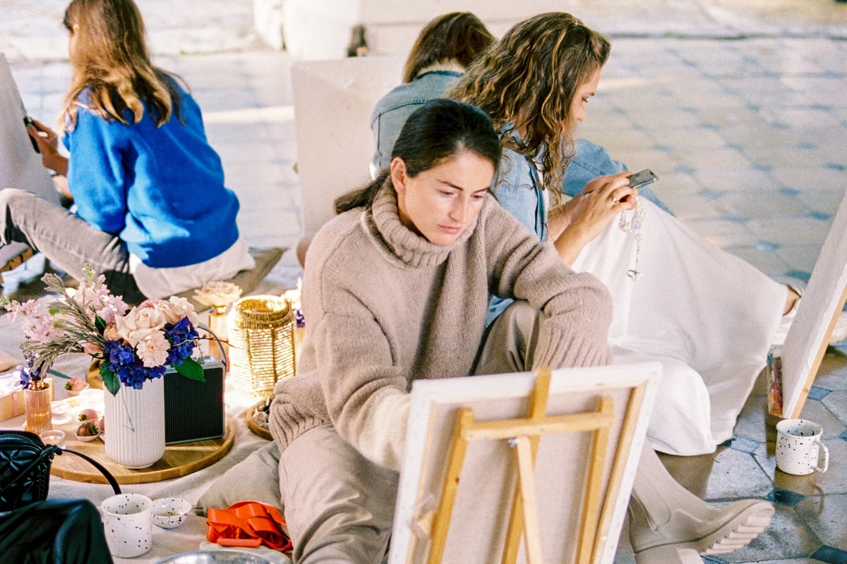 Women painting together during a relaxed creative workshop